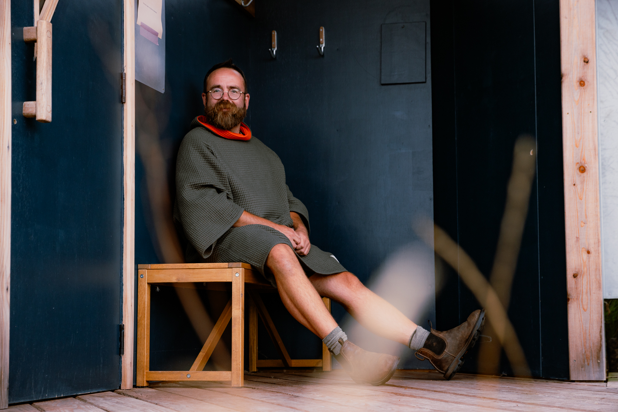 Man sat on bench wearing FARMERS' Waffle robe in Army Green