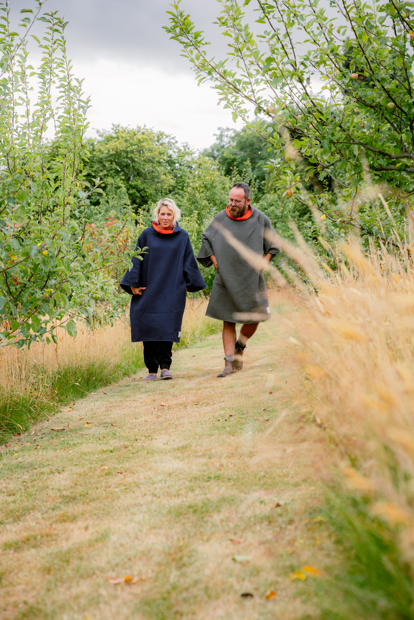 Man & woman wearing FARMERS' Waffle robes walking through countryside
